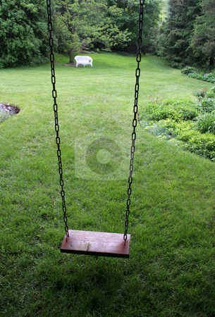 To use this stock image in your creative project, please select the size you need over to the right and click the "Add to Cart" button.
Your downloaded image will come with the Cutcaster watermark removed so don’t worry about the watermark you see on this page. Yard Swing stock photo, An old wooden swing sitting in a lush backyard. by Chris Hill
