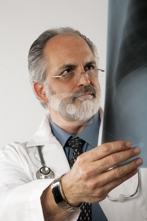 To use this stock image in your creative project, please select the size you need over to the right and click the "Add to Cart" button.
Your downloaded image will come with the Cutcaster watermark removed so don’t worry about the watermark you see on this page. Doctor Looking at X-ray. Isolated stock photo, Portrait of a doctor wearing eyeglasses and a white lab coat and looking intently at an x-ray. Vertical shot. Isolated on white. by Edward Bock