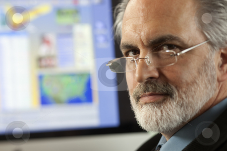 To use this stock image in your creative project, please select the size you need over to the right and click the "Add to Cart" button.
Your downloaded image will come with the Cutcaster watermark removed so don’t worry about the watermark you see on this page. Businessman Wearing Glasses stock photo, Close-up portrait of a businessman wearing eyeglasses and looking at the camera with a computer monitor in the background. Horizontal shot. by Edward Bock