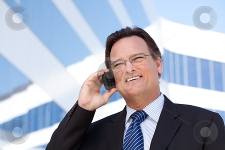 To use this stock image in your creative project, please select the size you need over to the right and click the "Add to Cart" button.
Your downloaded image will come with the Cutcaster watermark removed so don’t worry about the watermark you see on this page. Businessman Smiles as He Talks on His Cell Phone stock photo, Confident, Handsome Businessman Smiles as He Talks on His Cell Phone. by Andy Dean
