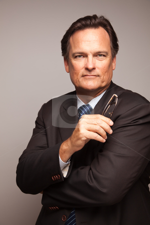 To use this stock image in your creative project, please select the size you need over to the right and click the "Add to Cart" button.
Your downloaded image will come with the Cutcaster watermark removed so don’t worry about the watermark you see on this page. Handsome Businessman Portrait on White stock photo, Handsome Businessman Smiling in Suit and Tie Isolated on a Grey Background. by Andy Dean