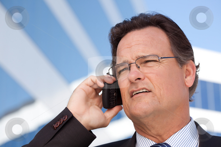 To use this stock image in your creative project, please select the size you need over to the right and click the "Add to Cart" button.
Your downloaded image will come with the Cutcaster watermark removed so don’t worry about the watermark you see on this page. Businessman Smiles as He Talks on His Cell Phone stock photo, Confident, Handsome Businessman Smiles as He Talks on His Cell Phone. by Andy Dean