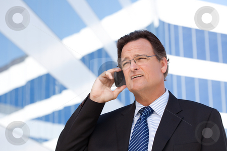 To use this stock image in your creative project, please select the size you need over to the right and click the "Add to Cart" button.
Your downloaded image will come with the Cutcaster watermark removed so don’t worry about the watermark you see on this page. Businessman Smiles as He Talks on His Cell Phone stock photo, Confident, Handsome Businessman Smiles as He Talks on His Cell Phone. by Andy Dean