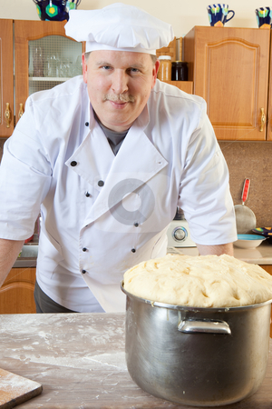 To use this stock image in your creative project, please select the size you need over to the right and click the "Add to Cart" button.
Your downloaded image will come with the Cutcaster watermark removed so don’t worry about the watermark you see on this page. Cook man in kitchen stock photo, Cook with big pastry pot by Ruta Balciunaite