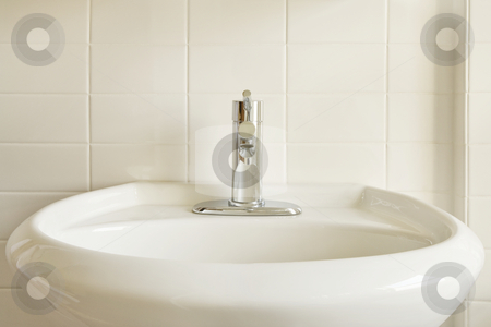 To use this stock image in your creative project, please select the size you need over to the right and click the "Add to Cart" button.
Your downloaded image will come with the Cutcaster watermark removed so don’t worry about the watermark you see on this page. White Porcelain Sink and White Tile stock photo, Close-up of a modern stainless steel faucet on an oval, white porcelain pedestal-style sink against a white tile wall. Horizontal format. by David Papazian