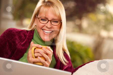 To use this stock image in your creative project, please select the size you need over to the right and click the "Add to Cart" button.
Your downloaded image will come with the Cutcaster watermark removed so don’t worry about the watermark you see on this page. Beautiful Woman Enjoys Her Warm Drink and Laptop stock photo, Beautiful, Smiling Woman Enjoys Her Warm Drink and Laptop Relaxing Day. by Andy Dean