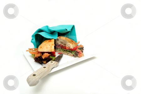 To use this stock image in your creative project, please select the size you need over to the right and click the "Add to Cart" button.
Your downloaded image will come with the Cutcaster watermark removed so don’t worry about the watermark you see on this page. Isolated BLT Sandwich stock photo, Bacon lettuce and tomato sandwich also known as a BLT on a Ciabatta roll served on a plate by Lynn Bendickson