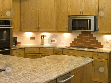 To use this stock image in your creative project, please select the size you need over to the right and click the "Add to Cart" button.
Your downloaded image will come with the Cutcaster watermark removed so don’t worry about the watermark you see on this page. Modern kitchen stock photo, Photo image of a mopdern kitchen with granite countertops by P.J. Lalli