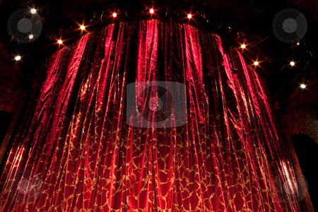 To use this stock image in your creative project, please select the size you need over to the right and click the "Add to Cart" button.
Your downloaded image will come with the Cutcaster watermark removed so don’t worry about the watermark you see on this page. Red Curtain stock photo, A velvet red theater curtain with traces of gold by Kevin Tietz