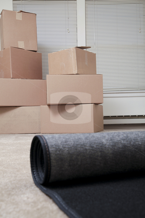 To use this stock image in your creative project, please select the size you need over to the right and click the "Add to Cart" button.
Your downloaded image will come with the Cutcaster watermark removed so don’t worry about the watermark you see on this page. Just moved in stock photo, A rug being unrolled in an empty house with boxes in the background by Christy Thompson