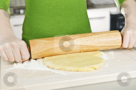 To use this stock image in your creative project, please select the size you need over to the right and click the "Add to Cart" button.
Your downloaded image will come with the Cutcaster watermark removed so don’t worry about the watermark you see on this page. Hands with rolling pin and cookie dough stock photo, Spreading out cookie dough with wooden rolling pin by Elena Elisseeva