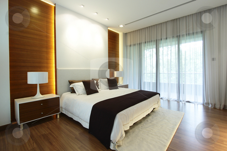 To use this stock image in your creative project, please select the size you need over to the right and click the "Add to Cart" button.
Your downloaded image will come with the Cutcaster watermark removed so don’t worry about the watermark you see on this page. Modern bedroom stock photo, Interior view of a modern bedroom by Adrin Shamsudin