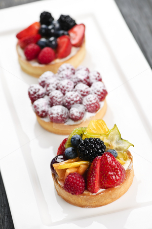 To use this stock image in your creative project, please select the size you need over to the right and click the "Add to Cart" button.
Your downloaded image will come with the Cutcaster watermark removed so don’t worry about the watermark you see on this page. Fruit tarts stock photo, Closeup of fancy gourmet fresh fruit dessert tarts by Elena Elisseeva