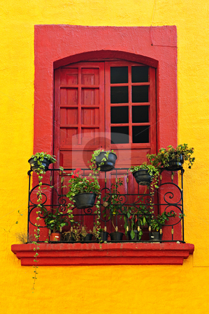 To use this stock image in your creative project, please select the size you need over to the right and click the "Add to Cart" button.
Your downloaded image will come with the Cutcaster watermark removed so don’t worry about the watermark you see on this page. Window on Mexican house stock photo, Red painted window with plants and wrought iron railing in Mexico by Elena Elisseeva