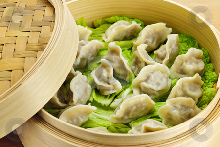 To use this stock image in your creative project, please select the size you need over to the right and click the "Add to Cart" button.
Your downloaded image will come with the Cutcaster watermark removed so don’t worry about the watermark you see on this page. Bamboo steamer with dumplings stock photo, Closeup of bamboo steamer with cooked dumplings by Elena Elisseeva