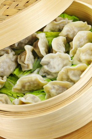 To use this stock image in your creative project, please select the size you need over to the right and click the "Add to Cart" button.
Your downloaded image will come with the Cutcaster watermark removed so don’t worry about the watermark you see on this page. Bamboo steamer with dumplings stock photo, Closeup of bamboo steamer with cooked dumplings by Elena Elisseeva