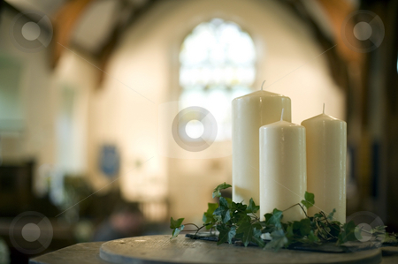 To use this stock image in your creative project, please select the size you need over to the right and click the "Add to Cart" button.
Your downloaded image will come with the Cutcaster watermark removed so don’t worry about the watermark you see on this page. Church candles stock photo, A narrow depth of field image of the interior of a church focusing only on three white candles by Stephen Gibson