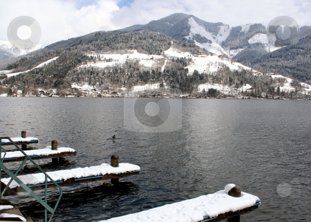 To use this stock image in your creative project, please select the size you need over to the right and click the "Add to Cart" button.
Your downloaded image will come with the Cutcaster watermark removed so don’t worry about the watermark you see on this page. Alpine lake and mountains stock photo, Scenic view of Alpine lake and mountains under cloudscape with snow covered jetty in foreground. by Martin Crowdy