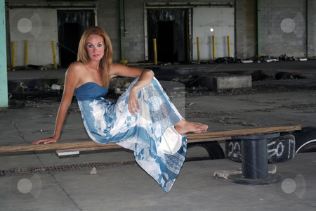 To use this stock image in your creative project, please select the size you need over to the right and click the "Add to Cart" button.
Your downloaded image will come with the Cutcaster watermark removed so don’t worry about the watermark you see on this page. Beautiful Redhead at an Abandoned Warehouse (1) stock photo, A lovely young redhead sits on a makeshift bench at a long-abandoned warehouse facility. by Carl Stewart