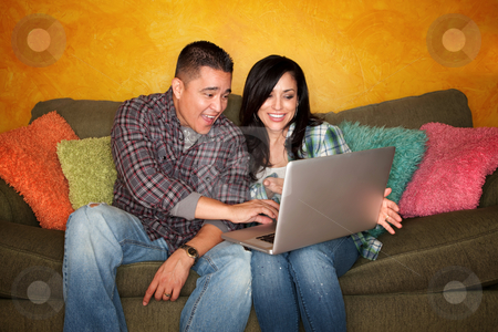 To use this stock image in your creative project, please select the size you need over to the right and click the "Add to Cart" button.
Your downloaded image will come with the Cutcaster watermark removed so don’t worry about the watermark you see on this page. Hispanic Couple with Computer stock photo, Hispanic Couple on Green Couch with Computer by Scott Griessel