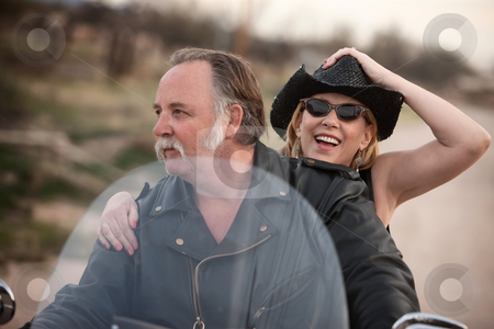 To use this stock image in your creative project, please select the size you need over to the right and click the "Add to Cart" button.
Your downloaded image will come with the Cutcaster watermark removed so don’t worry about the watermark you see on this page. Mature couple riding a motorcycle in the desert stock photo, Mature couple riding on a motorcycle in the desert by Scott Griessel