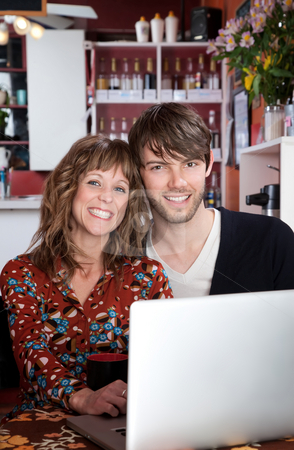 To use this stock image in your creative project, please select the size you need over to the right and click the "Add to Cart" button.
Your downloaded image will come with the Cutcaster watermark removed so don’t worry about the watermark you see on this page. Happy young couple stock photo, Happy young couple browsing the internet at a cafe by Scott Griessel