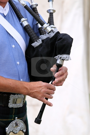 To use this stock image in your creative project, please select the size you need over to the right and click the "Add to Cart" button.
Your downloaded image will come with the Cutcaster watermark removed so don’t worry about the watermark you see on this page. Playing bagpipe stock photo, Close up of someone playing a bagpipe by Henrik Lehnerer