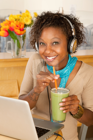 To use this stock image in your creative project, please select the size you need over to the right and click the "Add to Cart" button.
Your downloaded image will come with the Cutcaster watermark removed so don’t worry about the watermark you see on this page. Woman With Laptop and Smoothie stock photo, Woman works on her laptop while holding a smoothing and smiling at the camera. Vertical shot by Scott Griessel
