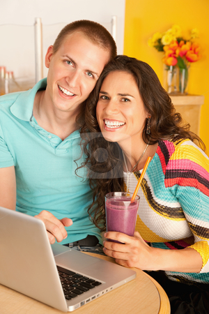 To use this stock image in your creative project, please select the size you need over to the right and click the "Add to Cart" button.
Your downloaded image will come with the Cutcaster watermark removed so don’t worry about the watermark you see on this page. Couple Dining Out Using a Laptop stock photo, Two people at a cafe drinking frozen beverages and using a laptop. Vertical shot. by Scott Griessel