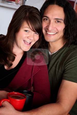 To use this stock image in your creative project, please select the size you need over to the right and click the "Add to Cart" button.
Your downloaded image will come with the Cutcaster watermark removed so don’t worry about the watermark you see on this page. Couple in a Cafe stock photo, Caucasian and Native American couple snuggling at a cafe by Scott Griessel