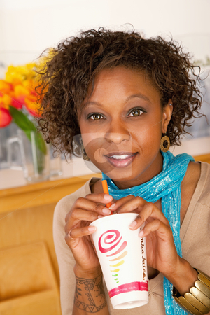 To use this stock image in your creative project, please select the size you need over to the right and click the "Add to Cart" button.
Your downloaded image will come with the Cutcaster watermark removed so don’t worry about the watermark you see on this page. Young Woman Drinking Beverage and Using Laptop stock photo, A young woman sitting in a cafe and drinking a beverage. Vertical shot. by Scott Griessel