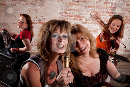 To use this stock image in your creative project, please select the size you need over to the right and click the "Add to Cart" button.
Your downloaded image will come with the Cutcaster watermark removed so don’t worry about the watermark you see on this page. Female musicians stock photo, All-girl band performing in stylish clothing at a warehouse by Scott Griessel