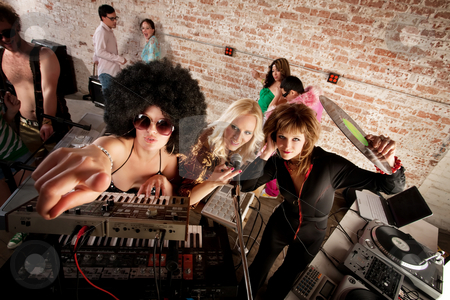 To use this stock image in your creative project, please select the size you need over to the right and click the "Add to Cart" button.
Your downloaded image will come with the Cutcaster watermark removed so don’t worry about the watermark you see on this page. 1970s Disco Music Party stock photo, Female DJs checking out the scene at a 1970s Disco Music Party by Scott Griessel