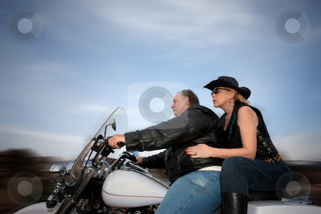 To use this stock image in your creative project, please select the size you need over to the right and click the "Add to Cart" button.
Your downloaded image will come with the Cutcaster watermark removed so don’t worry about the watermark you see on this page. Couple riding a motorcycle stock photo, Middle-aged couple riding a motorcycle in the desert by Scott Griessel