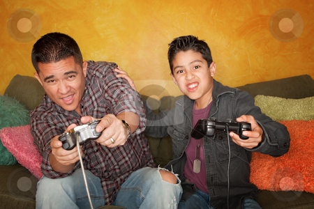 To use this stock image in your creative project, please select the size you need over to the right and click the "Add to Cart" button.
Your downloaded image will come with the Cutcaster watermark removed so don’t worry about the watermark you see on this page. Hispanic Man and Boy Playing Video game stock photo, Attractive Hispanic Man and Boy Playing a Video Game with Handheld Controllers by Scott Griessel