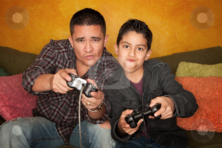 To use this stock image in your creative project, please select the size you need over to the right and click the "Add to Cart" button.
Your downloaded image will come with the Cutcaster watermark removed so don’t worry about the watermark you see on this page. Hispanic Man and Boy Playing Video game stock photo, Attractive Hispanic Man and Boy Playing a Video Game with Handheld Controllers by Scott Griessel