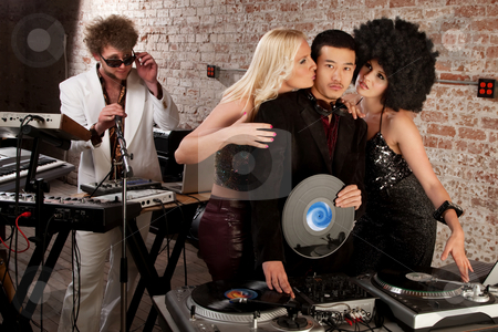 To use this stock image in your creative project, please select the size you need over to the right and click the "Add to Cart" button.
Your downloaded image will come with the Cutcaster watermark removed so don’t worry about the watermark you see on this page. 1970s Disco Music Party stock photo, Enviable Asian DJ with admiring female friends by Scott Griessel