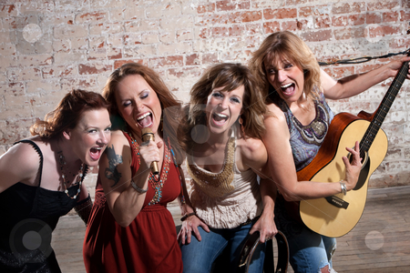 To use this stock image in your creative project, please select the size you need over to the right and click the "Add to Cart" button.
Your downloaded image will come with the Cutcaster watermark removed so don’t worry about the watermark you see on this page. Female musicians stock photo, All-girl band performing in stylish clothing at a warehouse by Scott Griessel