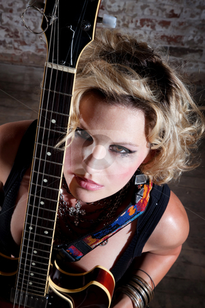 To use this stock image in your creative project, please select the size you need over to the right and click the "Add to Cart" button.
Your downloaded image will come with the Cutcaster watermark removed so don’t worry about the watermark you see on this page. Female punk rocker stock photo, Female punk rocker with her guitar in front of a brick background by Scott Griessel