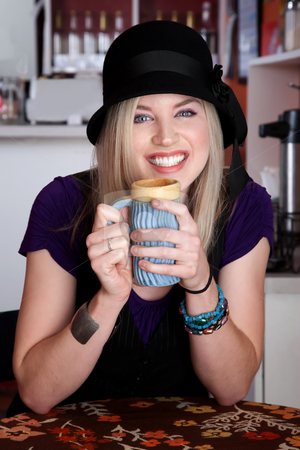 To use this stock image in your creative project, please select the size you need over to the right and click the "Add to Cart" button.
Your downloaded image will come with the Cutcaster watermark removed so don’t worry about the watermark you see on this page. Pretty Lady stock photo, Pretty lady smiling with aqua ceramic mug at a cafe by Scott Griessel