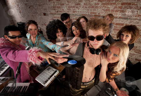 To use this stock image in your creative project, please select the size you need over to the right and click the "Add to Cart" button.
Your downloaded image will come with the Cutcaster watermark removed so don’t worry about the watermark you see on this page. 1970s Disco Music Party stock photo, DJ crowded by fans and requests at a party by Scott Griessel