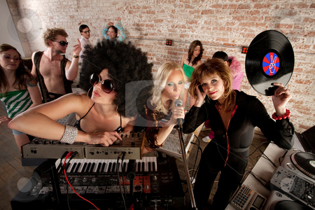 To use this stock image in your creative project, please select the size you need over to the right and click the "Add to Cart" button.
Your downloaded image will come with the Cutcaster watermark removed so don’t worry about the watermark you see on this page. 1970s Disco Music Party stock photo, Cool female DJs performing at a 1970s Disco Music Party by Scott Griessel