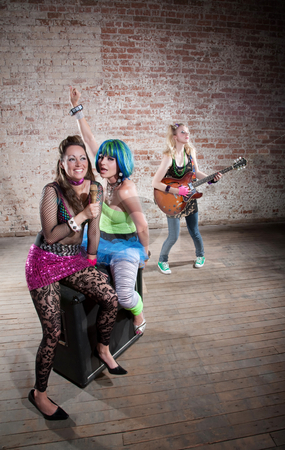 To use this stock image in your creative project, please select the size you need over to the right and click the "Add to Cart" button.
Your downloaded image will come with the Cutcaster watermark removed so don’t worry about the watermark you see on this page. Female punk rock band stock photo, Young all girl punk rock band performs in a warehouse by Scott Griessel