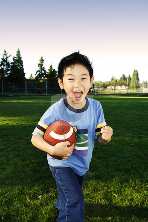 To use this stock image in your creative project, please select the size you need over to the right and click the "Add to Cart" button.
Your downloaded image will come with the Cutcaster watermark removed so don’t worry about the watermark you see on this page. Football boy stock photo, A happy boy playing football outdoor by Suprijono Suharjoto