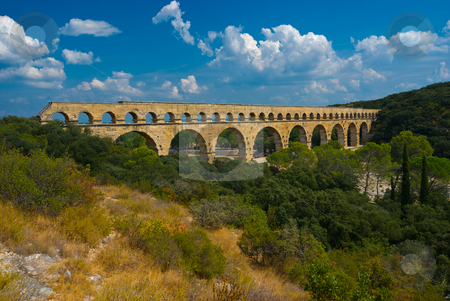 To use this stock image in your creative project, please select the size you need over to the right and click the "Add to Cart" button.
Your downloaded image will come with the Cutcaster watermark removed so don’t worry about the watermark you see on this page. Pont du Gard stock photo, Der Pont du Gard ist eine r?mische Aqu?duktbr?cke im S?den Frankreichs, nahe der Ortschaft Remoulins im D?partement Gard. - The Pont du Gard is an aqueduct in the South of France constructed by the Roman Empire, and located in Vers-Pont-du-Gard near Remoulins, in the Gard d?partement. by Wolfgang Heidasch