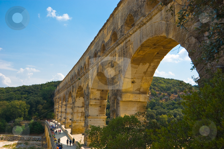 To use this stock image in your creative project, please select the size you need over to the right and click the "Add to Cart" button.
Your downloaded image will come with the Cutcaster watermark removed so don’t worry about the watermark you see on this page. Pont du Gard stock photo, Der Pont du Gard ist eine r?mische Aqu?duktbr?cke im S?den Frankreichs, nahe der Ortschaft Remoulins im D?partement Gard. - The Pont du Gard is an aqueduct in the South of France constructed by the Roman Empire, and located in Vers-Pont-du-Gard near Remoulins, in the Gard d?partement. by Wolfgang Heidasch
