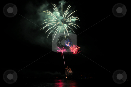 To use this stock image in your creative project, please select the size you need over to the right and click the "Add to Cart" button.
Your downloaded image will come with the Cutcaster watermark removed so don’t worry about the watermark you see on this page. Smoke And Fireworks stock photo, Colorful nighttime fireworks against a solid black sky over Lake Tahoe on the fourth of July holiday 2010 by Lynn Bendickson