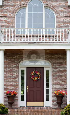 To use this stock image in your creative project, please select the size you need over to the right and click the "Add to Cart" button.
Your downloaded image will come with the Cutcaster watermark removed so don’t worry about the watermark you see on this page. Luxury Home Entrance stock photo, The front entrance of a large custom built luxury home in a residential neighborhood. by Todd Arena