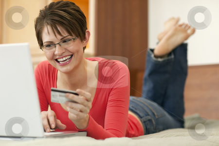 To use this stock image in your creative project, please select the size you need over to the right and click the "Add to Cart" button.
Your downloaded image will come with the Cutcaster watermark removed so don’t worry about the watermark you see on this page. Young Woman Shopping Online stock photo, Attractive young woman holds up the credit card she is using to shop with on her laptop computer. Horizontal shot. by Edward Bock