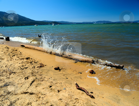 To use this stock image in your creative project, please select the size you need over to the right and click the "Add to Cart" button.
Your downloaded image will come with the Cutcaster watermark removed so don’t worry about the watermark you see on this page. Splashing Water Lake Tahoe stock photo, Summer day on the shore of lake Tahoe on the California side where a small wave crashes against waterlogged log and sends a splash of clear water upward with the sandy beach in the foreground. by Lynn Bendickson
